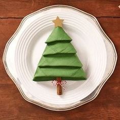 a paper christmas tree on a white plate