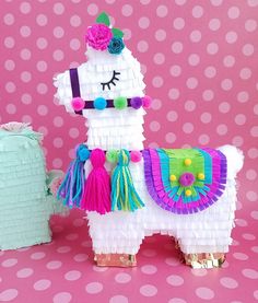 a llama made out of toilet paper on a pink background