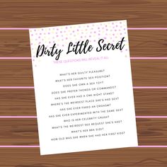 the dirty little secret game is shown on top of a wooden table with pink and white stripes