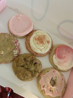 a box filled with lots of different types of cookies and frosting on top of each other