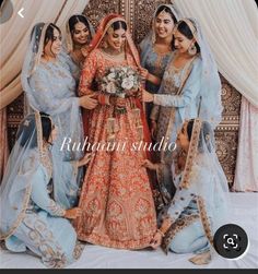 a group of women standing next to each other in front of a white curtain with the words rutuan studio on it