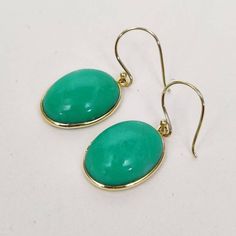 ITEM DESCRIPTION:  >> The earrings are made from Solid 14K Yellow Gold. Gemstone used is absolutely natural and ethically sourced. >> Natural Chrysoprase in Oval shape with bezel setting is studded on it with utmost precision.      >> This is a minimalist design and is absolutely hassle-free and everyday jewelry.  Gem: Chrysoprase  Gem size: 16x12 mm  Gem weight: 17.39 carats Gold purity: 14K (58.33% approx.) Gold weight: 0.78 grams  Gross weight: 4.26 grams The Gold purity is guaranteed and it comes with authentic 14K gold hallmark. Since these Earrings are handmade, they are Nickel/Lead FREE.  CUSTOMIZATION: --> You can choose your own gemstone. --> Kindly drop a message for more options. CUSTOMER SUPPORT: --> We are available 24/7 to respond to all your queries!  PACKAGING: --> The earr Classic Green Earrings With Bezel Setting, Round Chrysoprase Earrings Gift, Green Bezel Set Earrings For Formal Occasions, Formal Green Earrings With Bezel Setting, Green Earrings With Bezel Setting For May Birthstone, Elegant Handmade Chrysoprase Earrings, Handmade Elegant Chrysoprase Earrings, Gold Chrysoprase Gemstone Earrings, Green Cabochon Drop Earrings