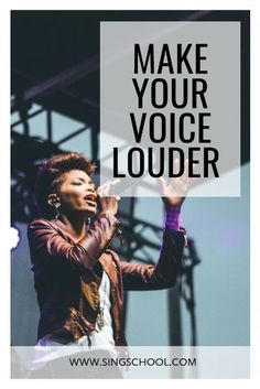 a woman singing on stage with the words make your voice louder