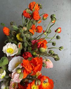 a vase filled with lots of different colored flowers