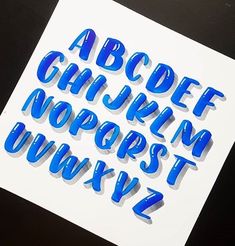 the upper and lower letters are cut out of paper with blue tape on top of them