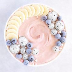 a bowl filled with fruit and nuts on top of a table