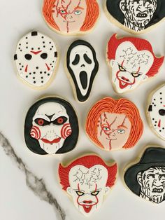 halloween cookies decorated to look like they have faces and mouths painted on them, all in different colors