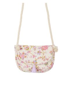 a white purse with flowers on it and a tassell hanging from the front