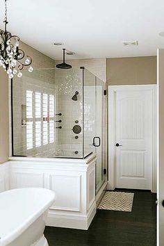 a large bathroom with a tub, shower and sink in the middle of it's walls