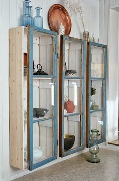 an old blue cabinet with glass doors in a room