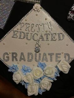 a decorated graduation cap with flowers on the front and words that read pretty, educated & graduated