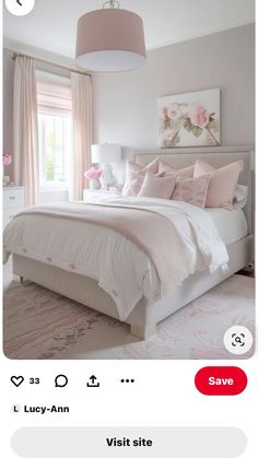 a white bed sitting in a bedroom next to a pink lamp hanging from a ceiling