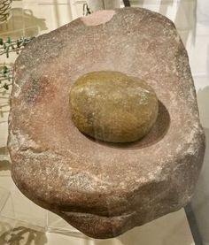 a rock sitting on top of a white table