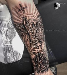 a person with a cross and angel tattoo on their arm