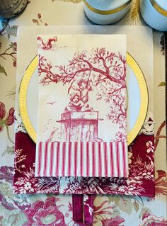 a place setting with red and white napkins