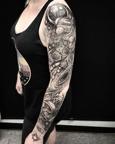 a woman with a black and white tattoo on her arm