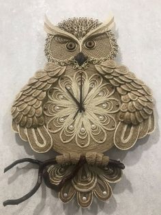 an owl clock is sitting on the wall