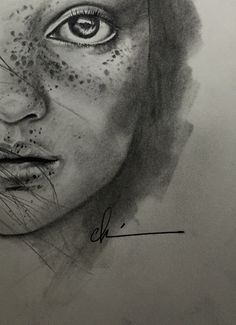 a pencil drawing of a woman's face with freckles on her skin