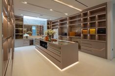 a modern kitchen with an island and built - in shelving