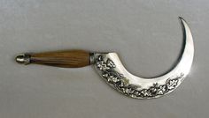 a silver and wood handle on a white surface