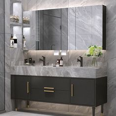 a bathroom with marble counter top and double sinks, mirrors and lights on the wall