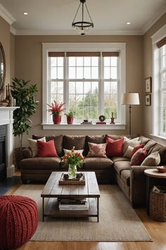 a living room filled with furniture and a fire place in front of a large window