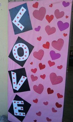 a pink door decorated with hearts and letters