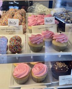 a display case filled with lots of different types of cupcakes