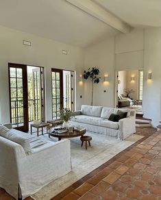 a living room filled with furniture and windows