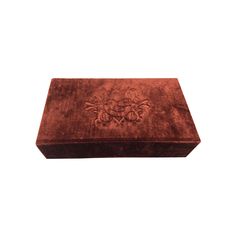 a red velvet box with an ornate design on the front and sides, isolated against a white background