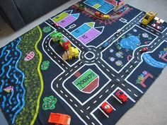 a child's play mat with cars and trucks on it