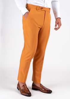 With a mustard-hue and stretch cotton fabric, you'll feel comfortable and stylish all day long in this unique custom made pants. Stand out and enjoy the compliments! Tailored Brown Cotton Pants, Yellow Tapered Leg Bottoms For Fall, Fitted Orange Straight Pants, Fitted Orange Ankle-length Pants, Fitted Mustard Bottoms For Workwear, Mustard Fitted Bottoms For Workwear, Yellow Cotton Pants For Fall, Casual Fitted Mustard Pants, Mustard Stretch Pants For Spring