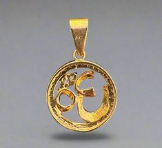 Om Pendant: Beautiful gold plate Om pendant with circle stone. An “Om” brass pendant is a symbolic piece of jewelry often worn to represent the sacred sound “Om” (or Aum), which is considered the universal sound in many spiritual traditions, especially in Hinduism and Buddhism. The Om symbol is often crafted with smooth, flowing lines that mimic the written character in Sanskrit, making it recognizable and deeply meaningful. Size: .75" diameter and 1" with hook Luxury Spiritual Jewelry For Puja, Cheap Spiritual Jewelry For Puja, Amulet Style Jewelry For Puja, Luxury Amulet Jewelry For Puja, Om Pendant, Buddhist Prayer, Om Symbol, Prayer Flags, Singing Bowl