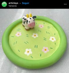 a small toy giraffe on top of a green plate