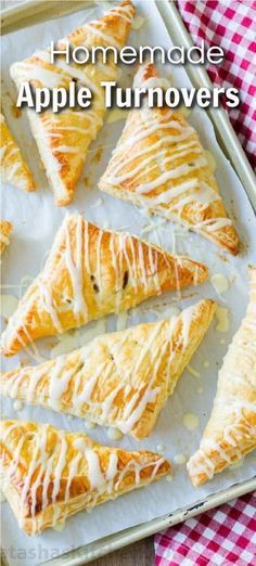 homemade apple turnoverers with white icing on a baking sheet and checkered table cloth