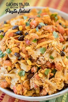 chicken fajita pasta salad in a white bowl on a colorful table cloth with the title above it