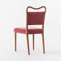 a wooden chair with a pink upholstered seat and back rest, viewed from the front