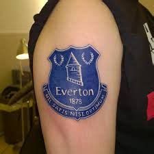 a man with a tattoo on his arm that says everton, it is national