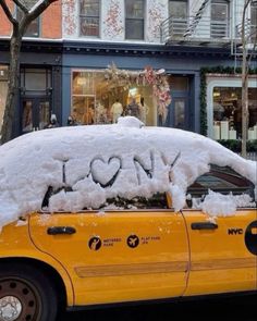 a taxi cab covered in snow with the word i love new york written on it