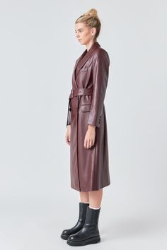 Our Premium Faux Leather Trench Coat is a wardrobe must-have. This effortlessly chic piece can be styled with all of your favorites, whether you want to pair it with baggy jeans and sneakers for a street-chic look or a mini dress and knee-high boots for date night. You can also cinch your waist with the removable buckle belt for a New York-inspired outfit. Crafted of luxurious faux leather fabric, this coat features a double-breasted design and a peak collar. Leather Long length Collar & Lapel W Chic Belted Leather Outerwear, Chic Leather Double-breasted Outerwear, Chic Double-breasted Leather Outerwear, Trendy Leather Business Outerwear, Trendy Belted Leather Outerwear, Trendy Leather Outerwear For Business Casual, Fashion-forward Leather Winter Outerwear, Luxury Fall Business Casual Outerwear, Leather Outerwear For Spring