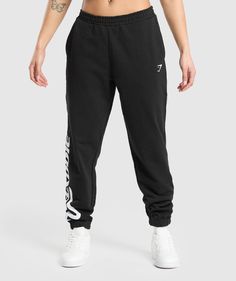 Gymshark Lifting Baddie Graphic Joggers - Black Trendy Bottoms With Logo Print For Streetwear, Trendy Streetwear Bottoms With Logo Print, Black Relaxed Fit Bottoms With Logo Print, Casual Black Pants With Logo Print, Black Logo Print Joggers For Streetwear, Black Graphic Print Bottoms, Casual Black Joggers With Logo Print, Black Cotton Joggers With Logo Print, Sports Bottoms With Graphic Print And Relaxed Fit