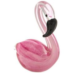 a pink glass flamingo sitting on top of a white table next to a black handle