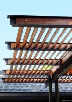 a wooden pergola on top of a roof