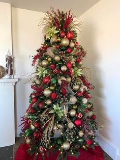 a decorated christmas tree with red and gold ornaments