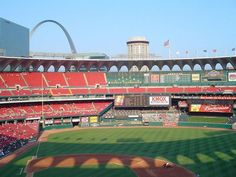 a baseball stadium with the st louis arch in the background