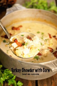 a spoon full of chicken chowder with corn in a pot and garnished with parsley