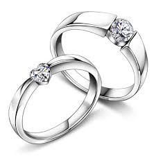 two white gold wedding rings with diamonds on each one and the other in between them