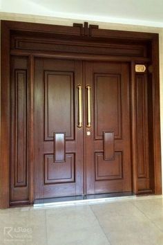 a large wooden door with two sidelights and an entry way leading to another room