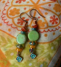 Colors of carnelian, turquoise, green, brown and mango make these very close to the amazing sunsets we have here in the desert.  I added a funky little geometric charm to finish the design.  A great all round pair of earrings, can be paired with many outfits. Green Spiritual Earrings With Natural Stones, Artisan Turquoise Czech Glass Earrings, Spiritual Green Earrings With Natural Stones, Artisan Czech Glass Turquoise Earrings, Green Beaded Dangle Earrings With Natural Stones, Multicolor Earthy Dangle Earrings, Earthy Multicolor Dangle Earrings, Earthy Turquoise Dangle Jewelry, Adjustable Green Beaded Earrings With Natural Stones