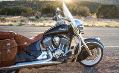 a black and brown motorcycle parked on the side of the road